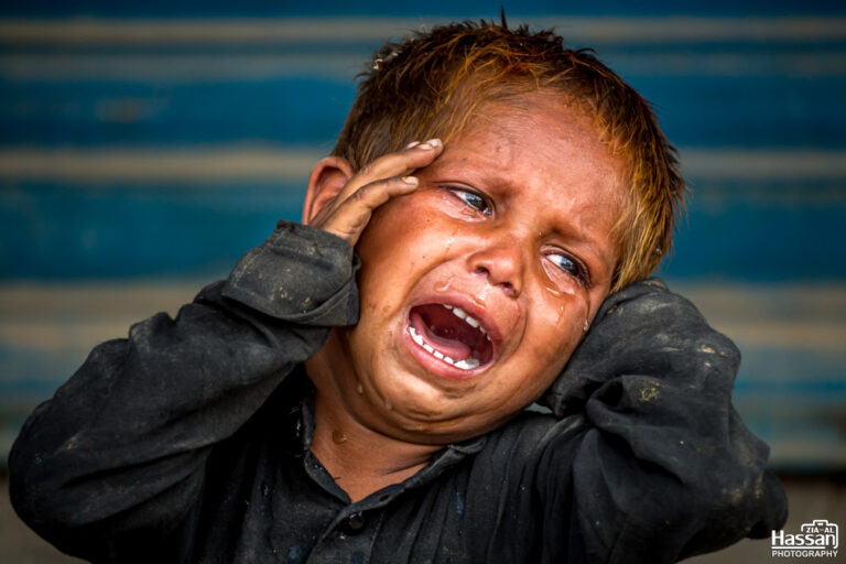 Little Boy Weeping With Hunger And Waiting For His Mother To Bring Food For Him