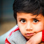 Innocent Child In Red Sweater On Road Side In Pir Mahal