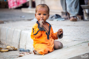 Poor Little Girl Of A Beggar Woman, Waiting For Her Mother