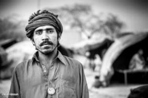 Black And White Portrait Of A Poor Man Living In Jhugi Basti Near Pir Mahal City